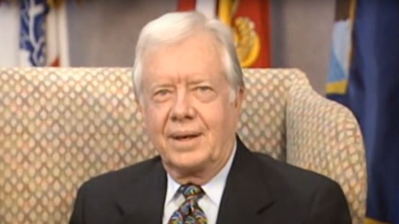 Jimmy Carter sits in a chair in Home Improvement