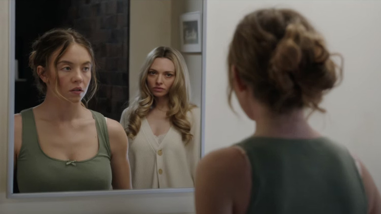 Millie looking in the mirror with Nina behind her in The Housemaid