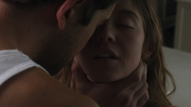 Andrew (Brandon Sklenar) holding Millie (Sydney Sweeney) at her neck in an intimate way in The Housemaid