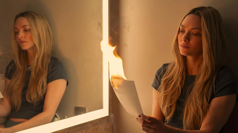 Nina burning a piece of paper in The Housemaid