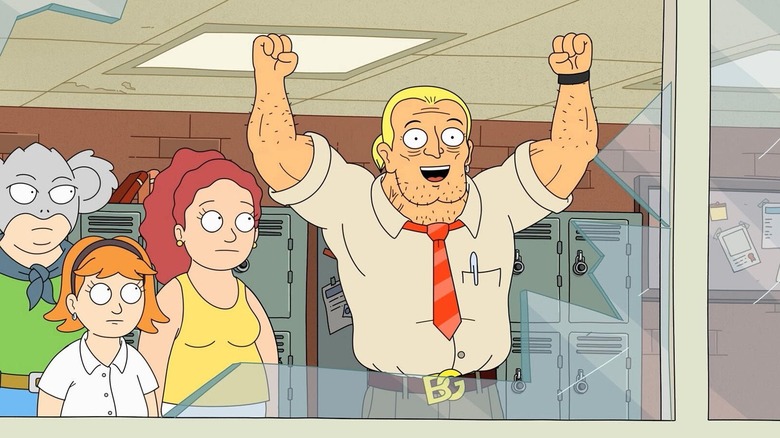 Big Greg smiling with his arms up looking at a smashed window in Koala Man