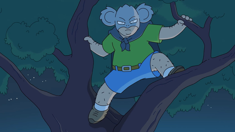 Kevin Williams in his hero costume hanging up a tree in Koala Man