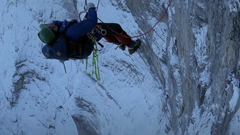 Clint Eastwood's Jonathan Hemlock hangs from a mountain via a safety rope in The Eiger Sanction