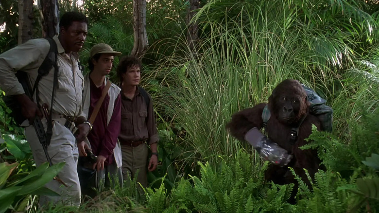 Amy using sign language to scare off the other gorilla while Peter, Monroe, and Richard watch in Cogno