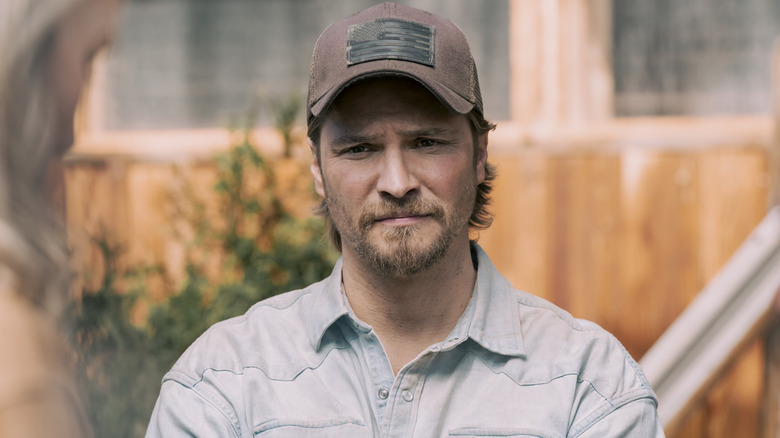 Luke Grimes' Kayce Dutton is seen in closeup as he stands outside in Marshals