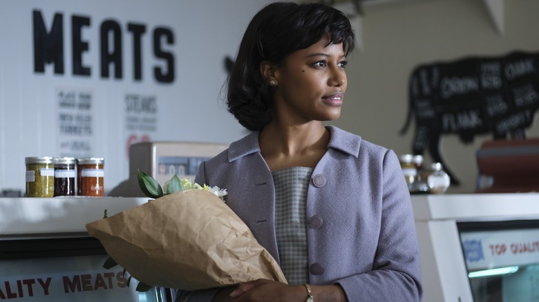 IT: Welcome to Derry, Charlotte Hanlon (Taylour Paige) standing in a butcher shop holding a bouquet