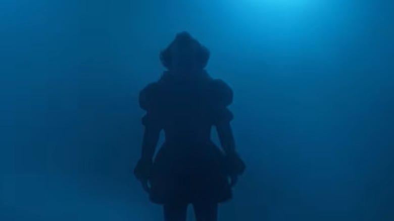 Pennywise standing in the fog in 