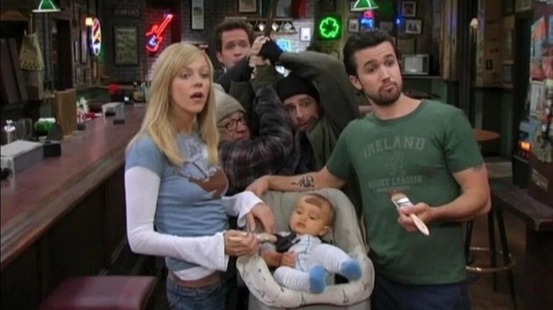 Dee and Mac paint a baby brown while Charlie, Frank, and Dennis fight over a sword on It's Always Sunny in Philadelphia