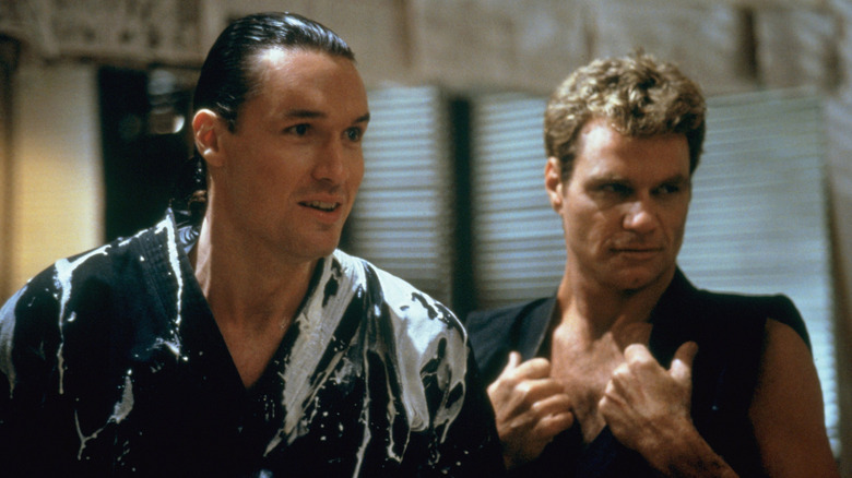 Terry Silver smiling devilishly beside John Kreese in The Karate Kid Part III