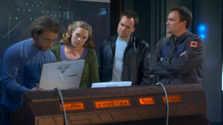 Radic Zellinka, Jenny Miller and Rodney McCai at a computer bank in Stargate Atlantis.