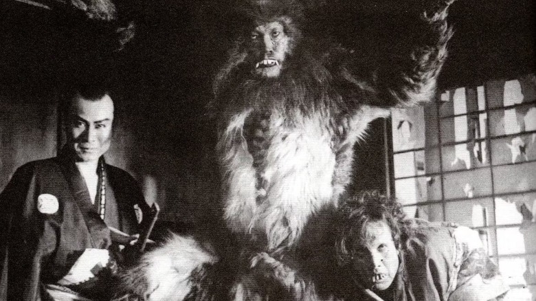 Kong stands between two men in 