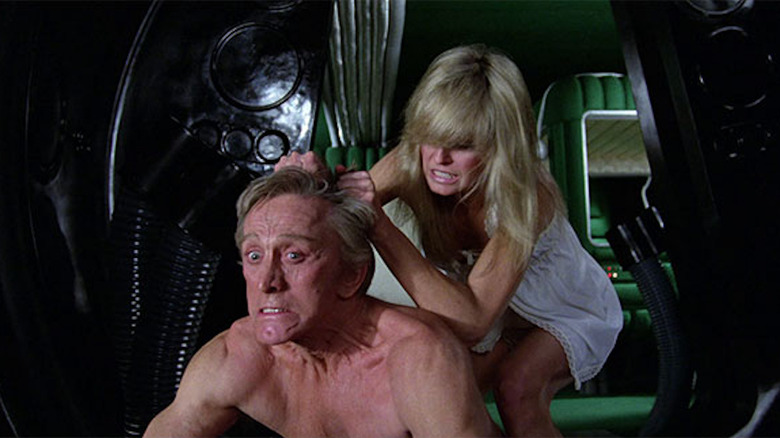 Farrah Fawcett's Alex yanks on the hair of Kirk Douglas' Adam in Saturn 3