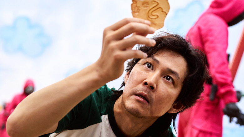 Seong Gi-Hun struggles to complete the candy game