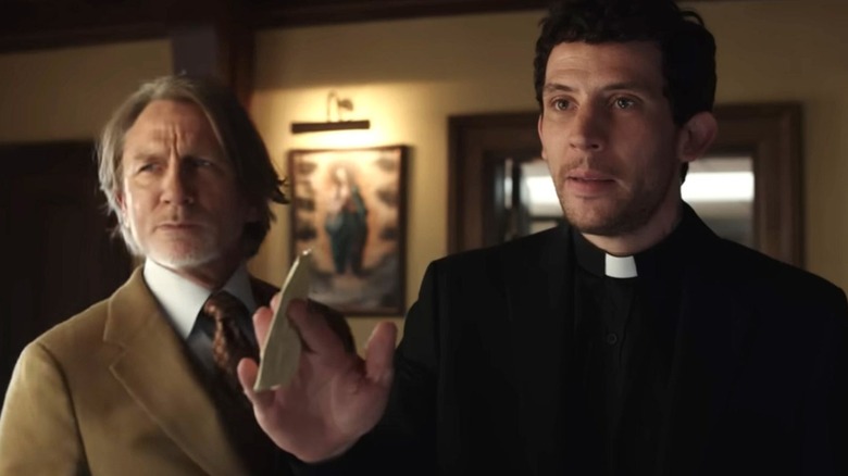 Blanc next to Jud holding a piece of paper in Wake Up Dead Man