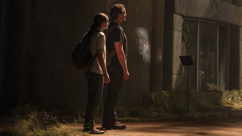 Ellie and Joel looking at something in The Last of Us