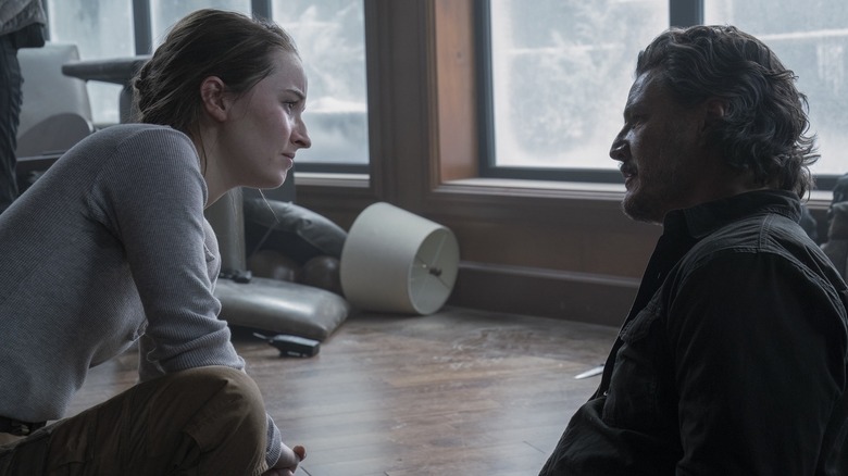 Abby looking at Joel on the ground in The Last of Us