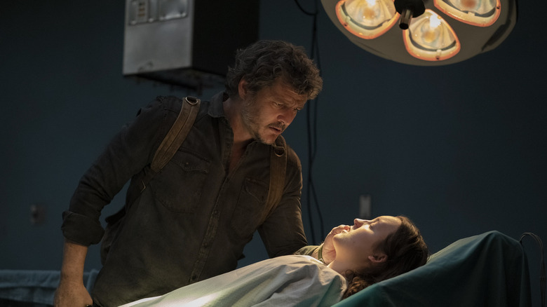 Joel looking at Ellie on the operating table in The Last of Us