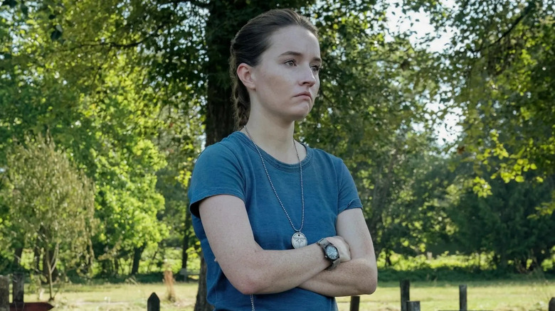 Kaitlyn Dever as Abby in front of a cross in The Last of Us