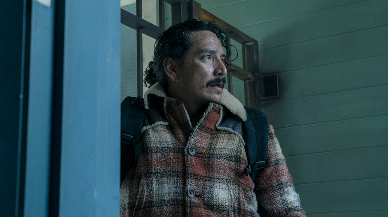 Tommy standing in a doorway looking at something off camera in The Last of Us season 2