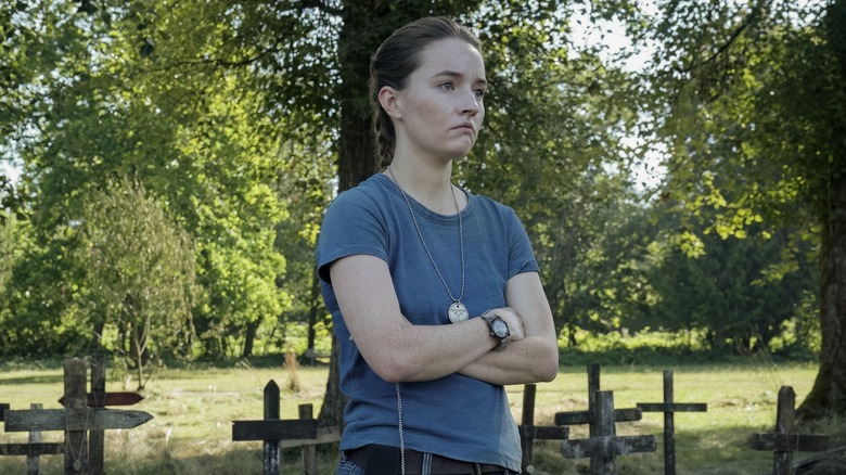 Abby standing by the graves of dead fireflies in The Last of Us season 2