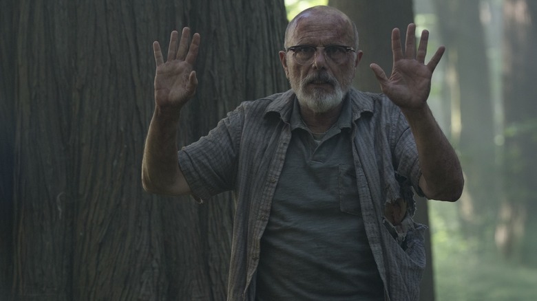 Eugene raises his hands in the air in The Last of Us