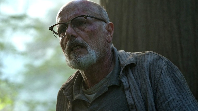 Joey Pants as Eugene, looking distraught in the woods in The Last of Us