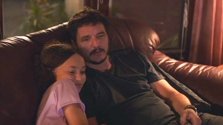 Pedro Pascal's Joel and Nico Parker's Sarah watch a movie in The Last of Us
