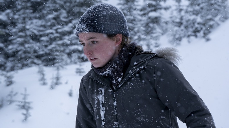 Abby wearing a hat in the snow on the last of us