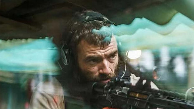A former DEA agent shooting a rifle in The Last Photograph