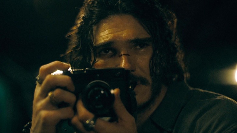 Ethan Black taking a photo in The Last Photograph