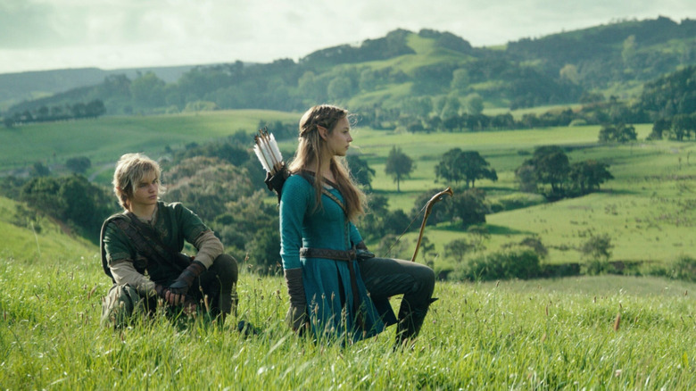 Link and Zelda sitting in a field together in The Legend of Zelda