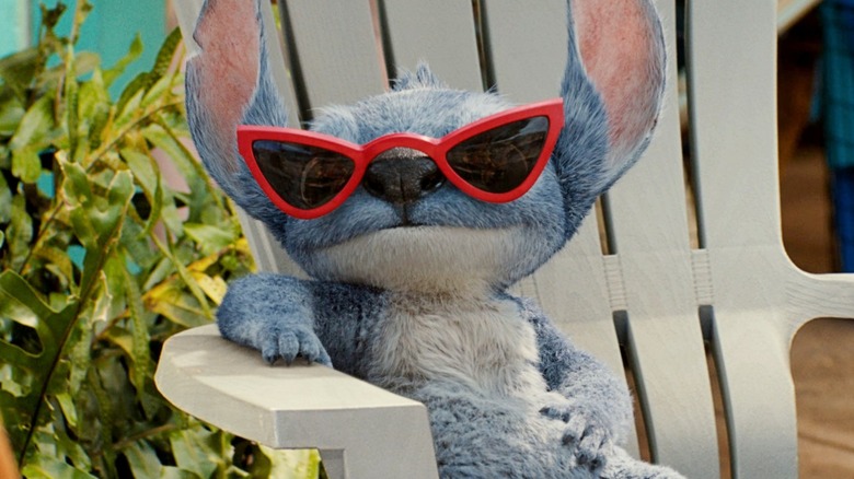 Stitch sits in a deckchair wearing sunglasses in Lilo & Stitch