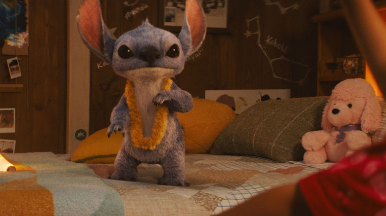 Chris Sanders as the voice of Stitch standing on a bed in Lilo & Stitch