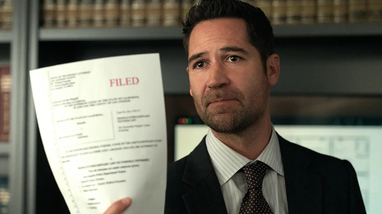 Mickey Haller holds up a filed legal document on "The Lincoln Lawyer"