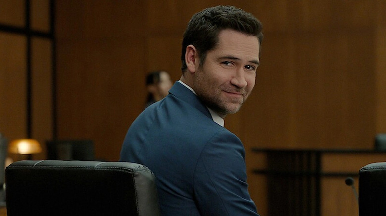 Mickey Haller smiling as he looks back in a courtroom in The Lincoln Lawyer