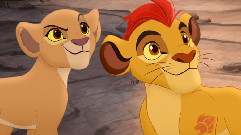Kiara and Kion stand next to each other and look toward the right on The Lion Guard