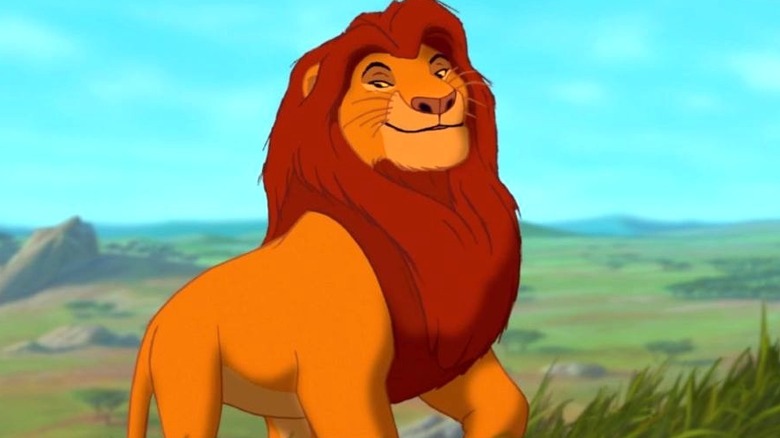 Mufasa standing in a field and smiling in The Lion King