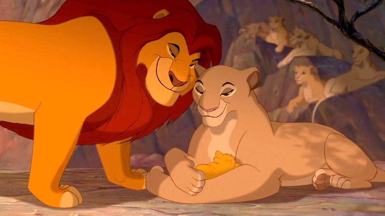 Sarabi holds Simba while Mufasa looks at them in The Lion King
