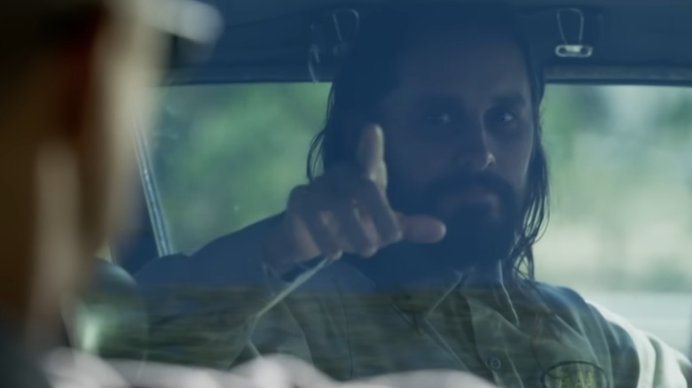 Jared Leto in a car pointing
