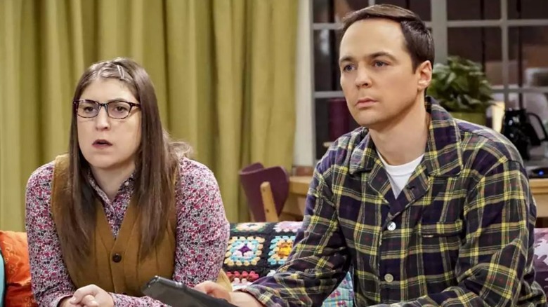 Amy and Sheldon are watching something intently on The Big Bang Theory