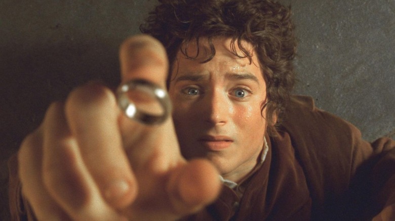 Frodo reaches for the One Ring in The Lord of the Rings