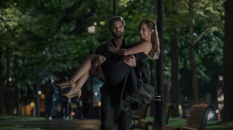 Tom carrying Olive outside in The Love Hypothesis