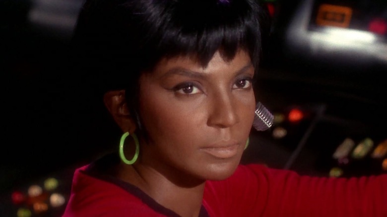 Uhura with a receiver in her ear on Star Trek