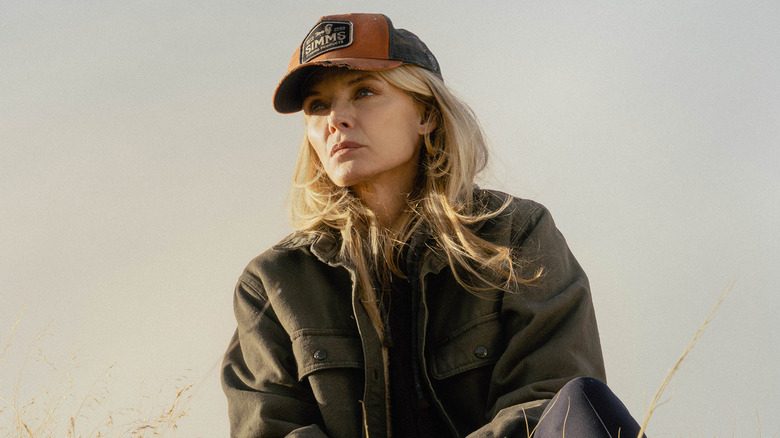 Michelle Pfeiffer's Stacy Clyburn sits on a hillside looking into the distance in The Madison