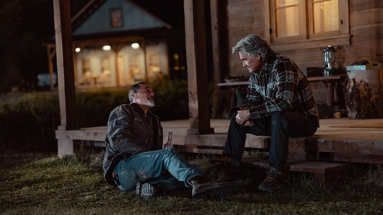 Matthew Fox's Paul Clyburn lays on the ground talking to Kurt Russell's Preston Clyburn outside a cabin in The Madison