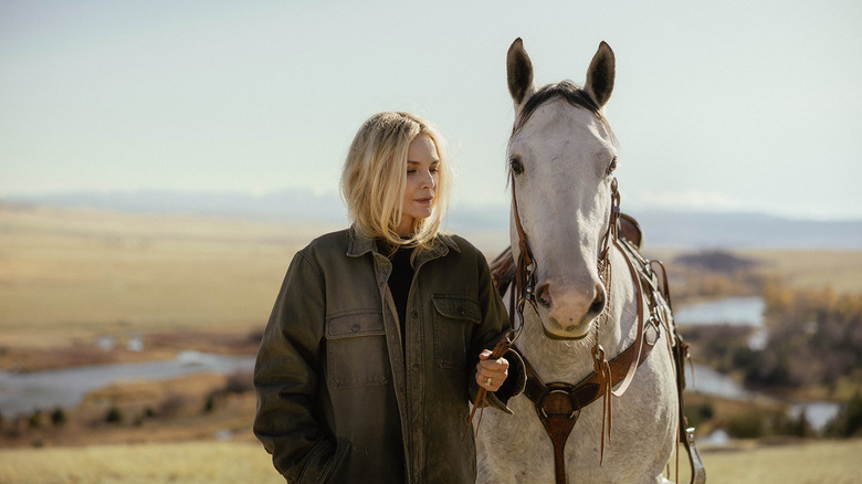 Michelle Pfeiffer's Stacy Clyburn stands next to a horse in Stacy's valley in The Madison