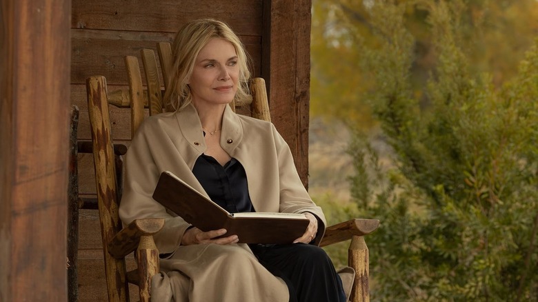 Michelle Pfeiffer as Stacy Clyburn sitting in a chair with a book in The Madison