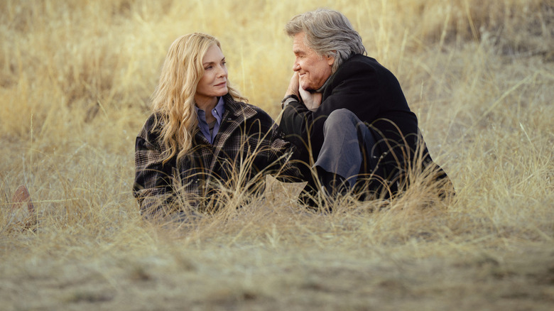 Stacy (Michelle Pfeiffer) en Preston (Kurt Russell) zitten in het gras op The Madison