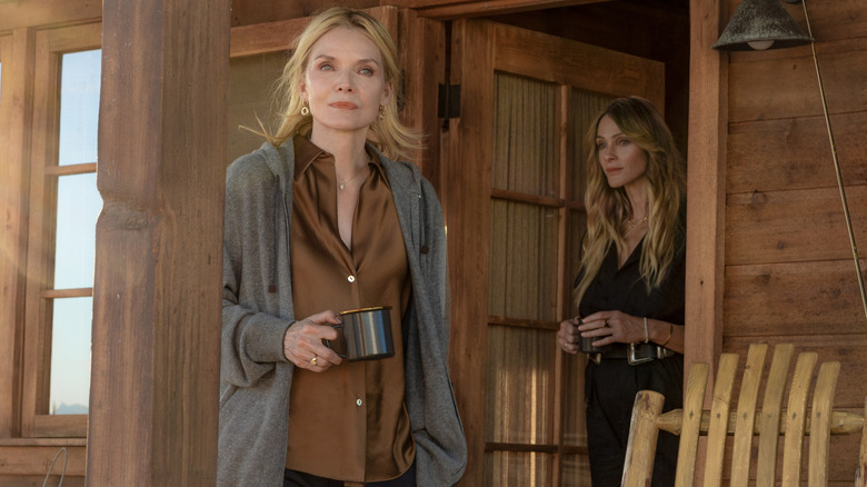 Michelle Pfeiffer as Stacy Clyburn and Beau Garett as Abigail Reese standing on the porch of a wood cabin in The Madison