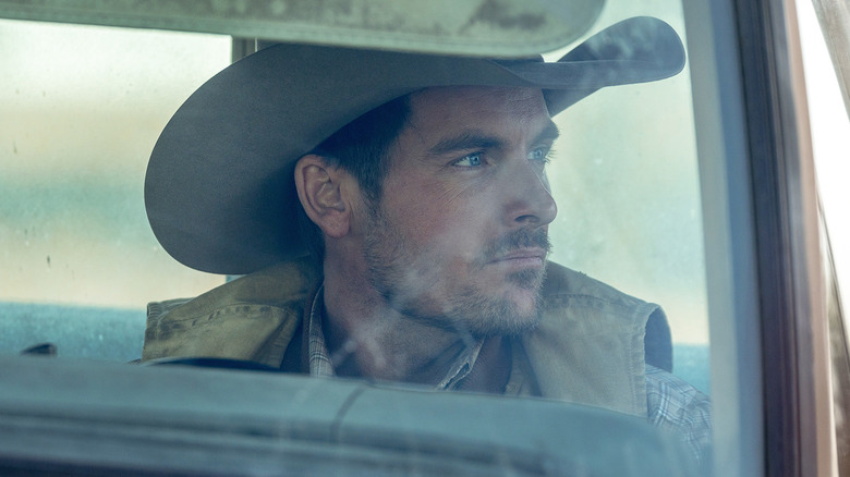 Kevin Zegers' Cade Harris looks off to his left as he sits in a car in The Madison